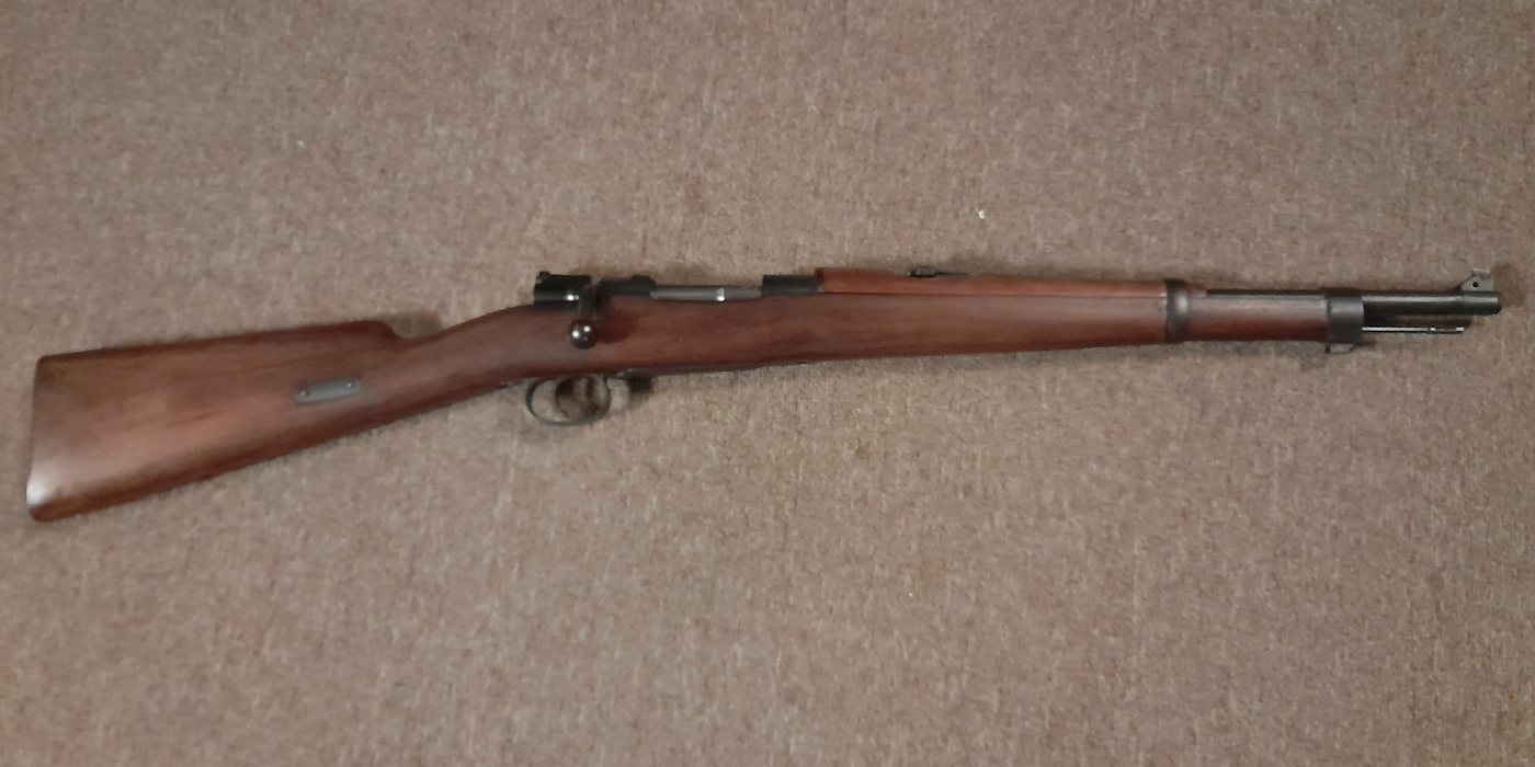 A Mauser-pattern short rifle laid on carpet